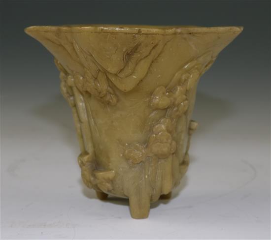 A Chinese pale green soapstone libation cup, 19th century, width 18.5cm, height 10cm, faults